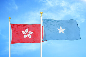 Hong Kong and Somalia two flags on flagpoles and blue cloudy sky