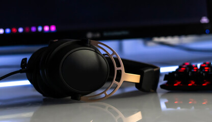 Plakat Gaming headphones with mirkophone and neon illumination diodes. Gaming devices, neon lights. Game zone.