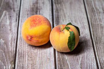 Pair of peaches fruit isolated on a wooden background