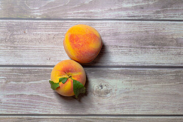 Pair of peaches fruit isolated on a wooden background