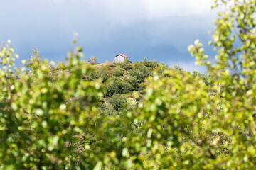 A small wooden wilderness hut on the top of a hill during summertime in Northern Finland. 