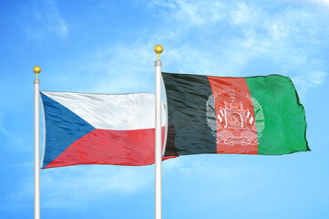 Naklejka na ściany i meble Czech and Afghanistan two flags on flagpoles and blue cloudy sky