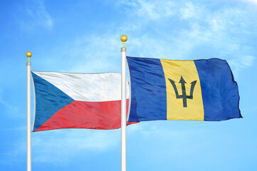 Czech and Barbados two flags on flagpoles and blue cloudy sky