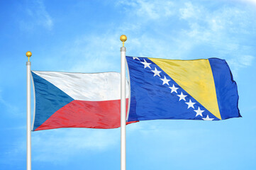Czech and Bosnia and Herzegovina two flags on flagpoles and blue cloudy sky