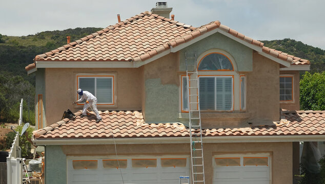 Wide Shot Of A Generic Suburban Home Being Re-painted    