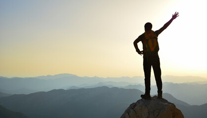 Fototapeta na wymiar silhouette of a man on a mountain top