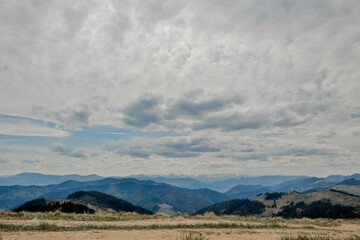 Carpathian Mountains top view landscape ridge summer season dramatic weather time with cloudy blue sky background