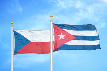 Czech and Cuba two flags on flagpoles and blue cloudy sky