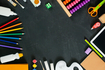 School supplies on black board background. Back to school concept. Frame, flatlat, copy space for text