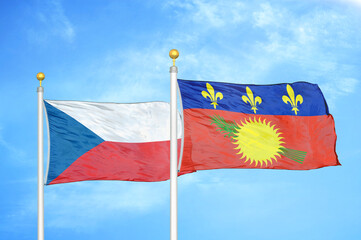 Czech and Guadeloupe two flags on flagpoles and blue cloudy sky