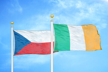 Naklejka na ściany i meble Czech and Ireland two flags on flagpoles and blue cloudy sky