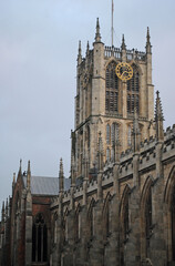 Fototapeta na wymiar Ornate Stone Gothic Church with Tower & Public Clock 