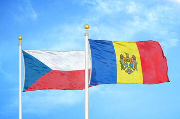 Czech and Moldova two flags on flagpoles and blue cloudy sky