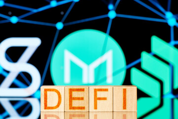 defi concept. wooden blocks with the defi inscription on the background of the Synthetix, Maker, Compound logos