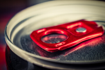Macro photografy lid of can of fizzy drink with bright red ring-opener