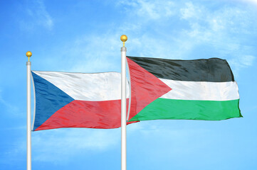 Czech and Palestine two flags on flagpoles and blue cloudy sky