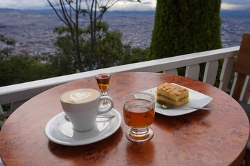 Canelazo and dessert on cafe table in Monserrate overlooking Bogotá Colombia