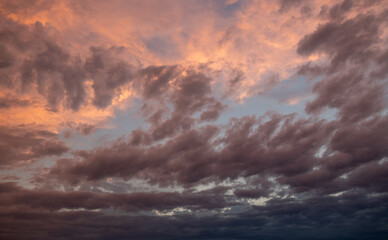 Fototapeta premium Pink sunset after rain. Black, thunderclouds and blue sky. Sunset at the sea. Summer. Georgia.