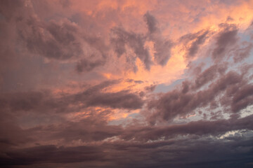 Pink sunset after rain. Black, thunderclouds and blue sky. Sunset at the sea. Summer. Georgia.