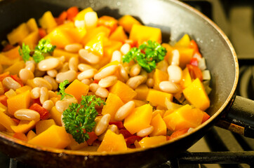 Vegetable stew with pumpkin and white beans in pan