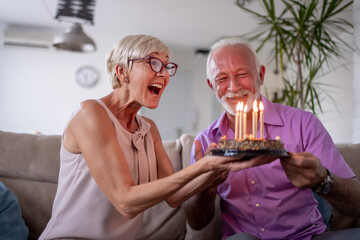 Senior couple celebrating at home.