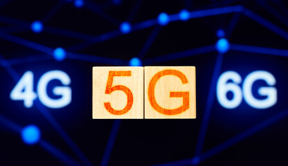 5g concept. wood blocks with 5g lettering on background with 4g and 6g lettering