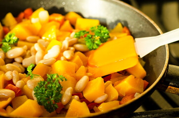 Vegetable stew with pumpkin and white beans in pan