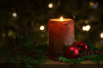 Pretty Christmas candle burning at night.