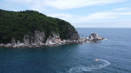 A jet ski gliding along a beautiful  sea shore