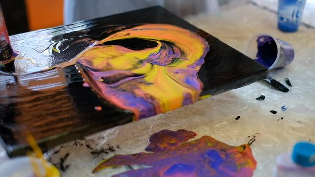 The artist paints with acrylic paints on canvas using a special technique.