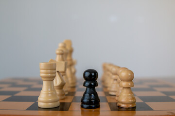 black pawn between white pieces, depth of field