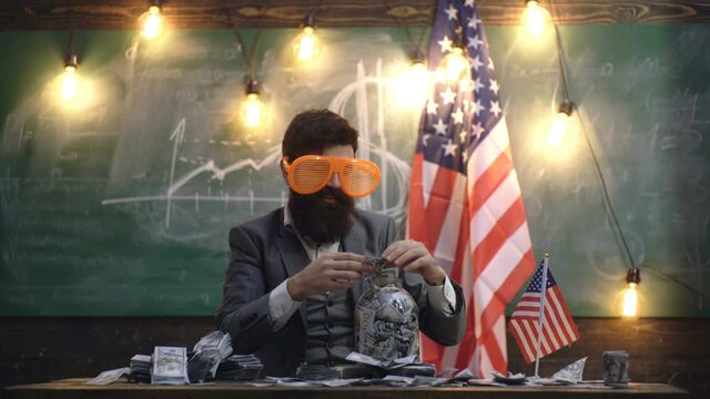 Funny businessman holding dollars in glass. Man with money having fun. Funny man with American currency, cash. Success economy.