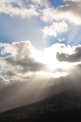 Clouds over the mountains, sunshine trough the clouds. Landscape from Santa Cruz de Tenerife, Canary Islands, Spain