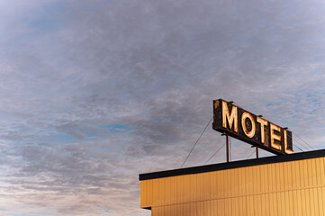 Motel neon sign over a cloudy sky