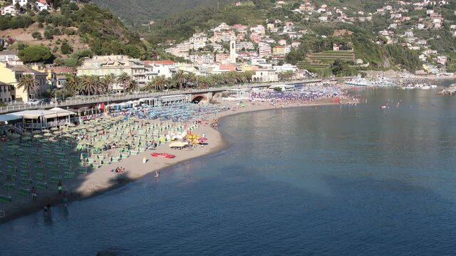 Five Lands, Italy - summer2020: tourists stroll on the beach of Moneglia, timelapse video