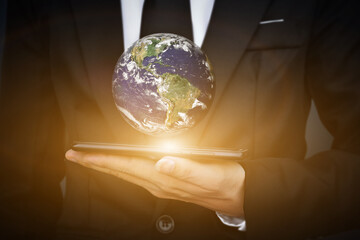 World earth day concept. Businessman hand holding mobile smartphone with Globe. Elements of this image furnished by NASA