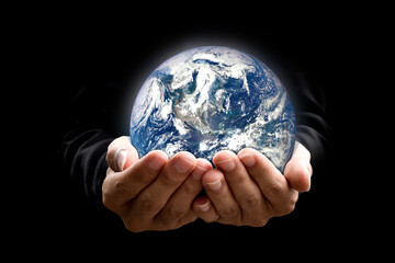 Environment concept. Earth in hands on black background. Elements of this image furnished by NASA