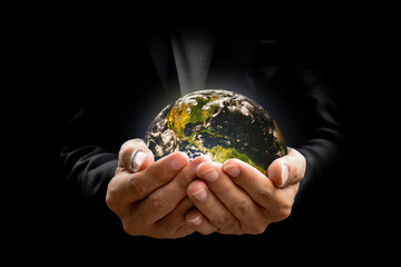 Environment concept. Earth in hands on black background. Elements of this image furnished by NASA