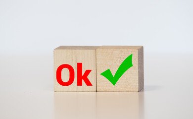 Word OK made with building blocks on white background with reflection.
