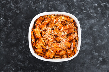 plant-based food, vegan rigatoni pasta bake with red pesto sauce and dairy free cheese