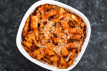 plant-based food, vegan rigatoni pasta bake with red pesto sauce and dairy free cheese