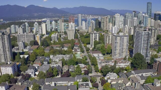 Aerial Panaramic view of condensed residential area of downtown Vancouver Canadas most popular residential are pre-pandemic busy streets with people and cars enjoying the westend beautiful summer day.