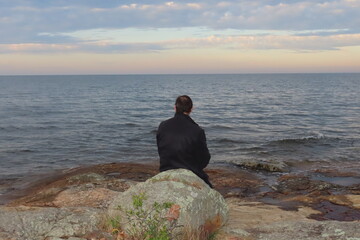 man meditating on the beach