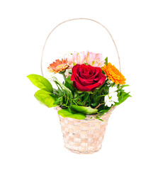 Wicker decorative basket with bouquet of beautiful flowers isolated on white background