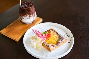 Homemade dessert delicious cake with peaches and icing sugar and cocoa drink - Peach Pie on white plate
