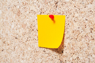 Sticky note on cork board
