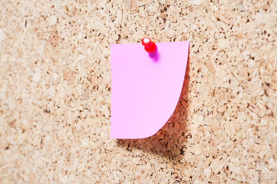 Sticky note on cork board

