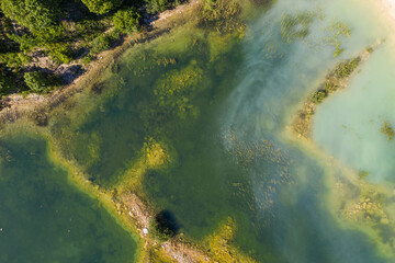 Aerial view of a shallow turquoise lake with a raised sandy bottom