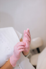 Hand in a pink latex medical gloves