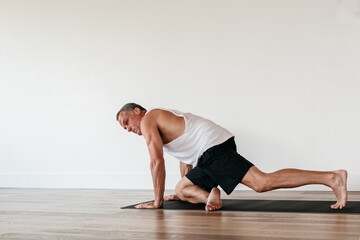 Fototapeta na wymiar Senior man doing yoga stretching
